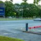 A car park barrier with a protective cover to reduce risk to pedestrians